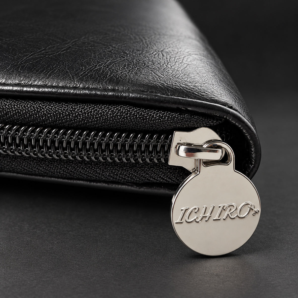 Close-up of the silver Ichiro zip pull and black zip on the scissor travel case